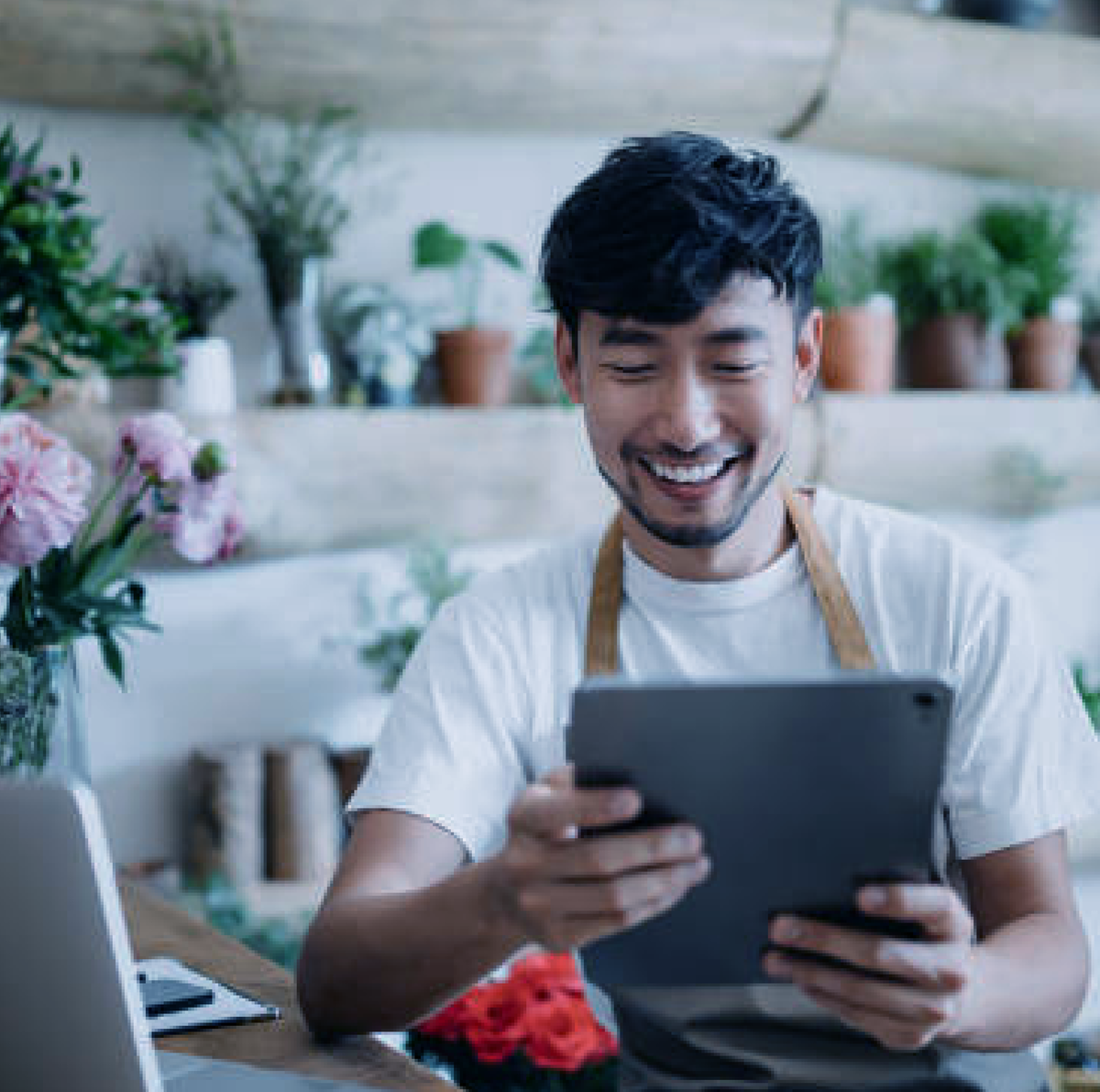 man smiling at tablet